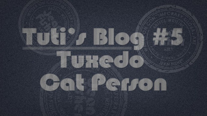 Tuxedo cat person text on a fabric background